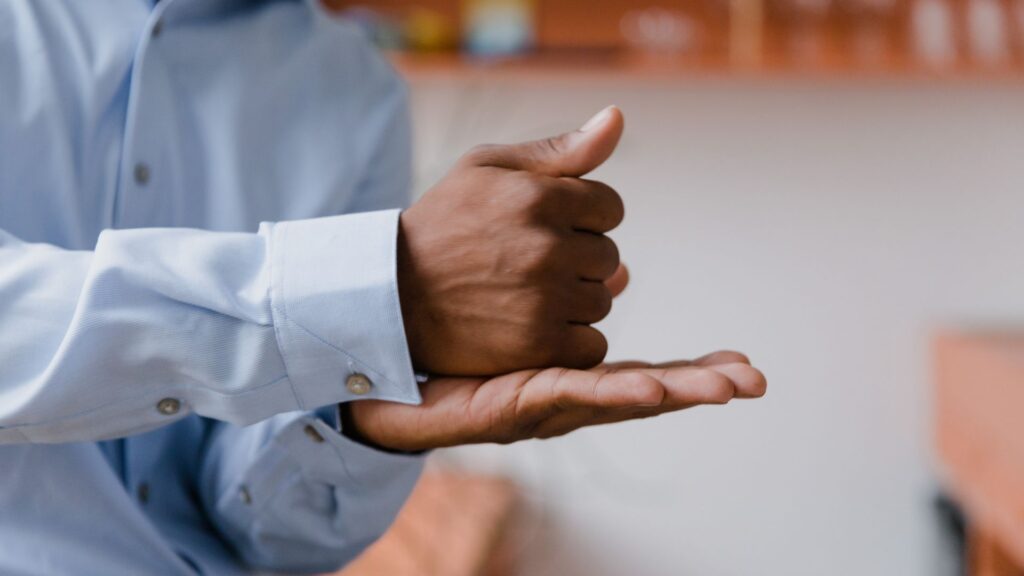 Close-up of a black man showing American Sign Language