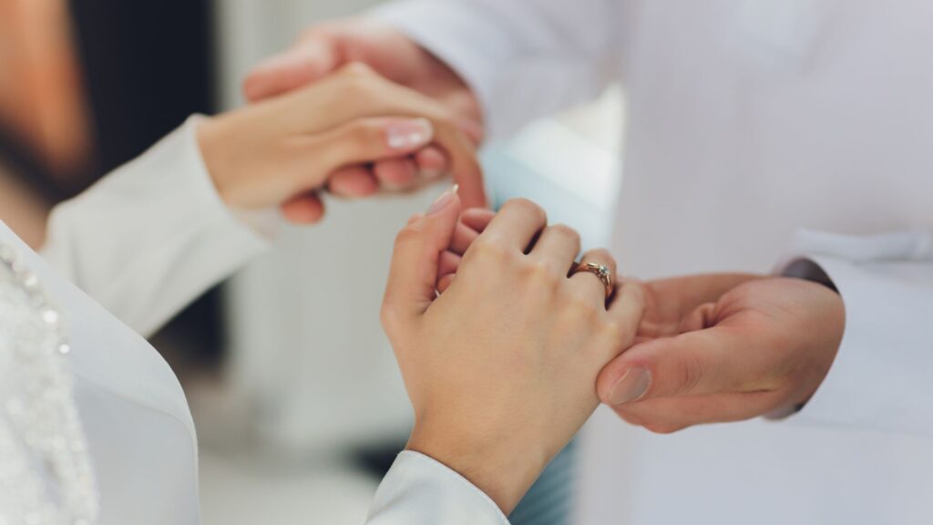 Muslim bride and groom holding hands